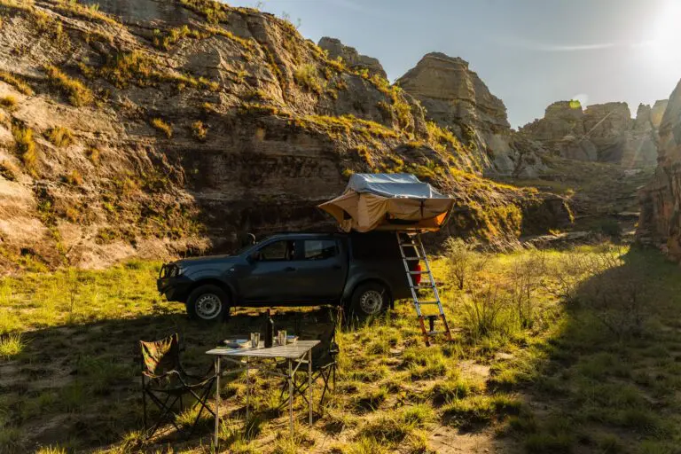 rooftop tent on a truck in a rocky canyon at sunset