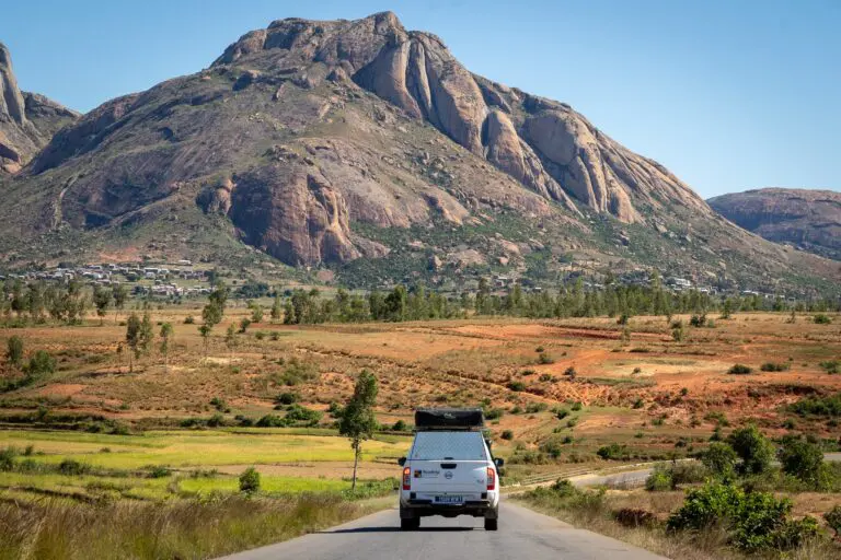 white pickup truck driving on a road in Madagascar mountains