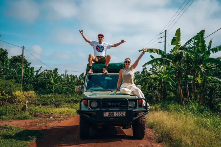 couple on safari jeep in Uganda with banana trees